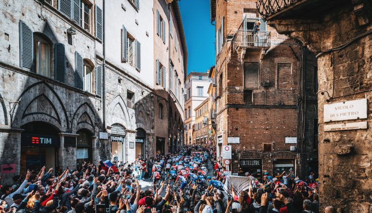 The-peloton-rides-through-Siena-Italy-during-stage-12-of-2021-Giro-dItalia.-©-Ashley-Jered-Gruber